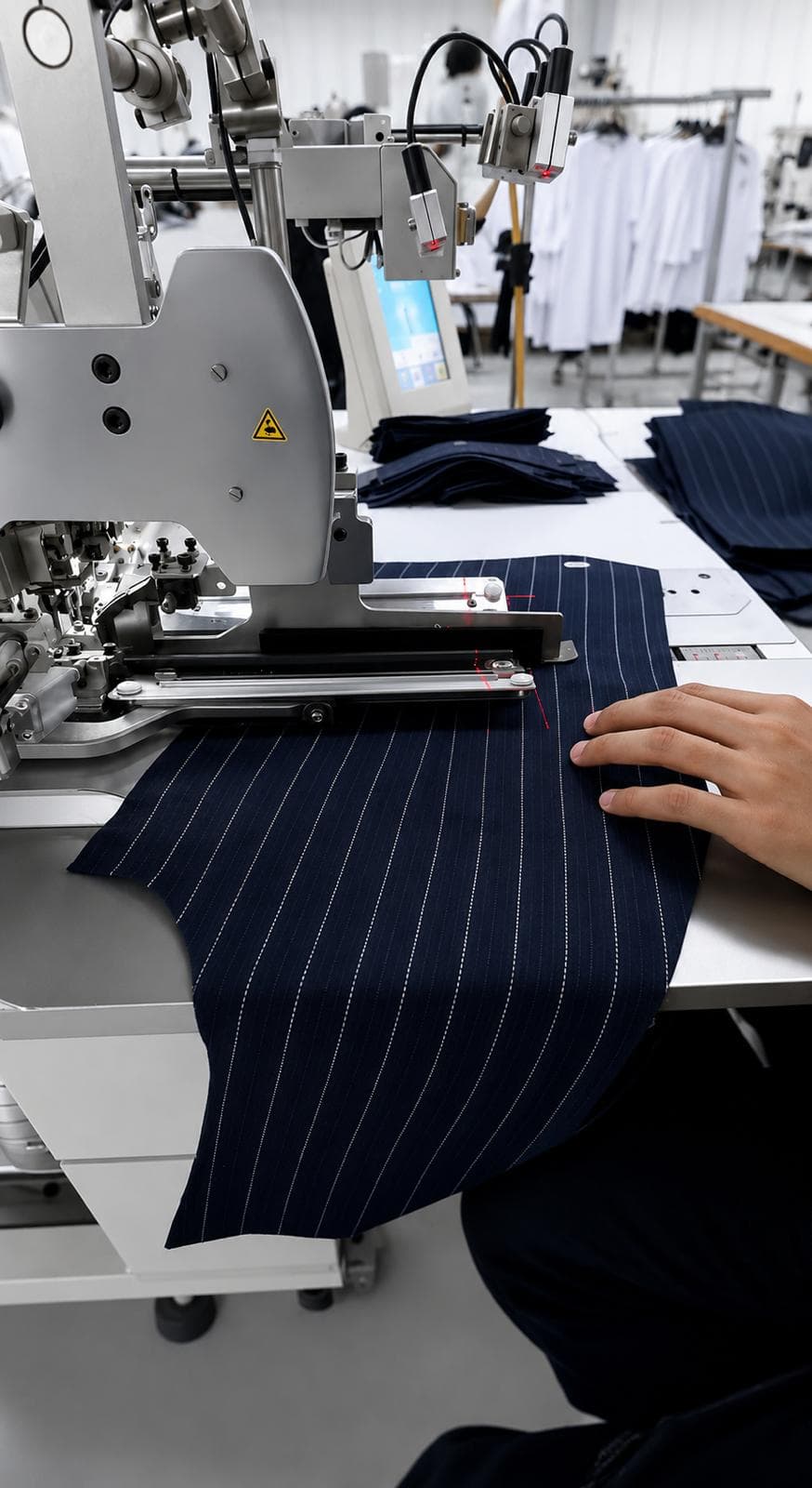 Garment production machine working on dark fabric in an Egyptian factory